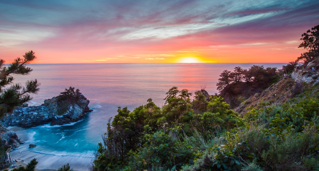 Pink and orange sunset over the beach at Big Sur