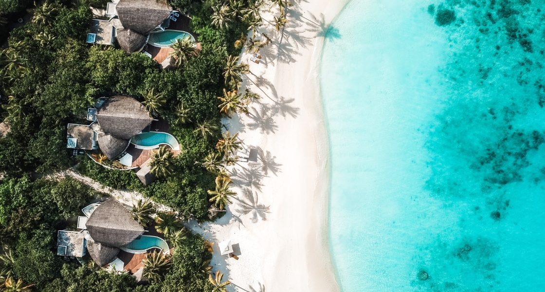 aerial picture of beach villas with private pools in The Maldives